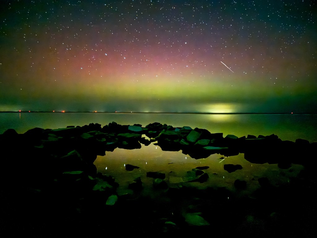 “Green aurora curtain stretching across the night sky above Peninsula State Park in Door County, Wisconsin, September 1, 2025, with stars scattered across the horizon.”